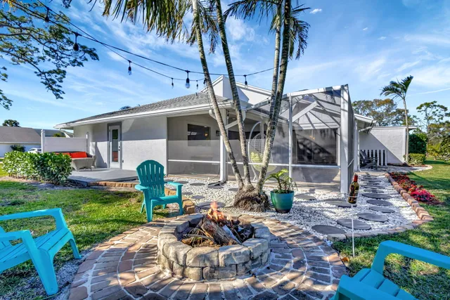 a view of a patio with table and chairs potted plants