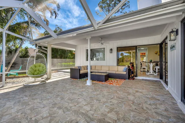 a living room with furniture a ceiling fan and a rug