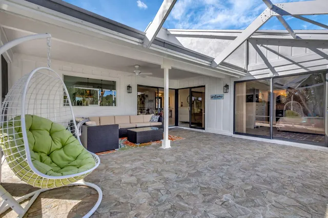 a front view of a house with a yard table and chairs