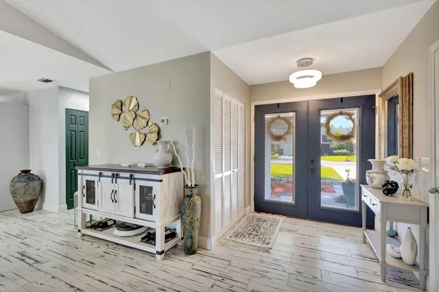 a view of an entryway with wooden floor
