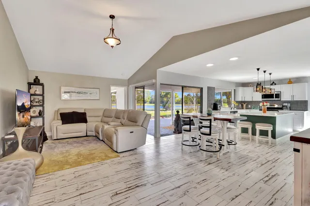 a living room with fireplace furniture and a wooden floor