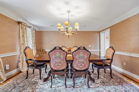a view of a dining room with furniture and chandelier