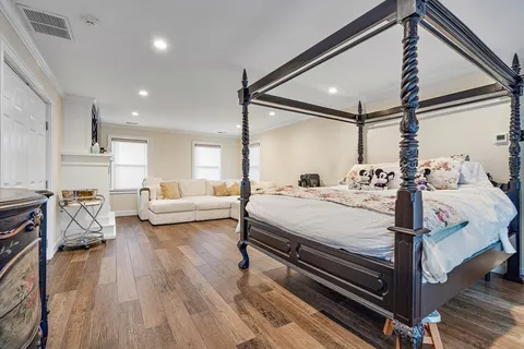 a bedroom with a bed and a night stand