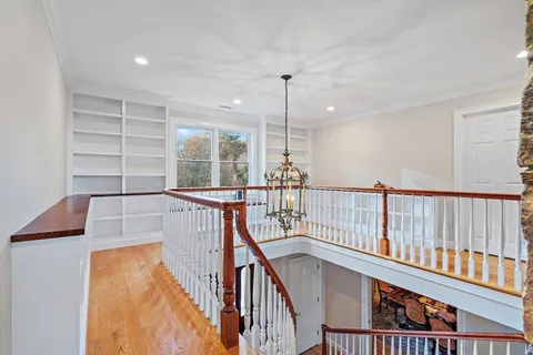 a view of entryway and hall with wooden floor