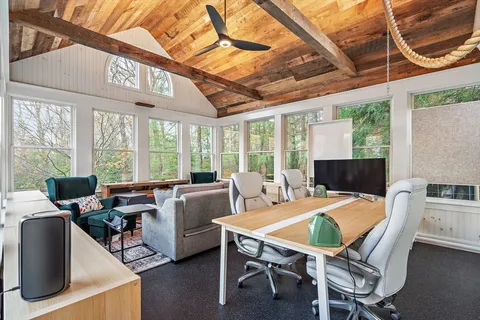 a media room with lots of chairs and a projector screen