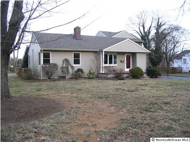 5 Spring Garden Road Lincroft, NJ 07738 - Photo 1 of 3 a front view of house with yard and trees around
