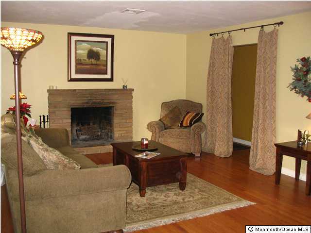 5 Spring Garden Road Lincroft, NJ 07738 - Photo 3 of 3 a living room with furniture and a fireplace