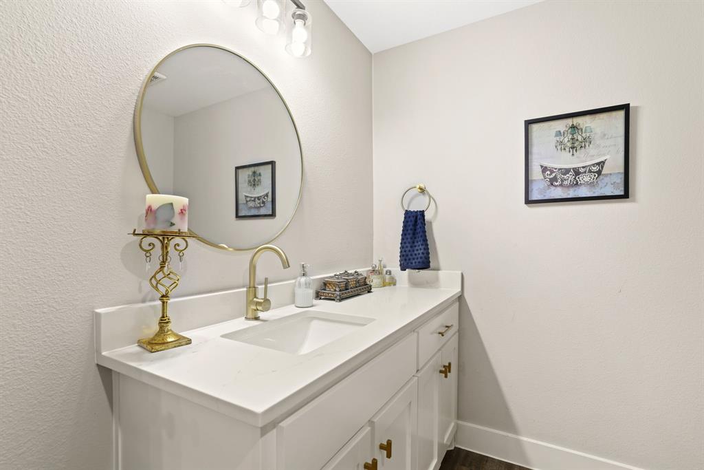 114 West Morton Street Denison, TX 75021 - Photo 11 of 22 a bathroom with a sink and a mirror