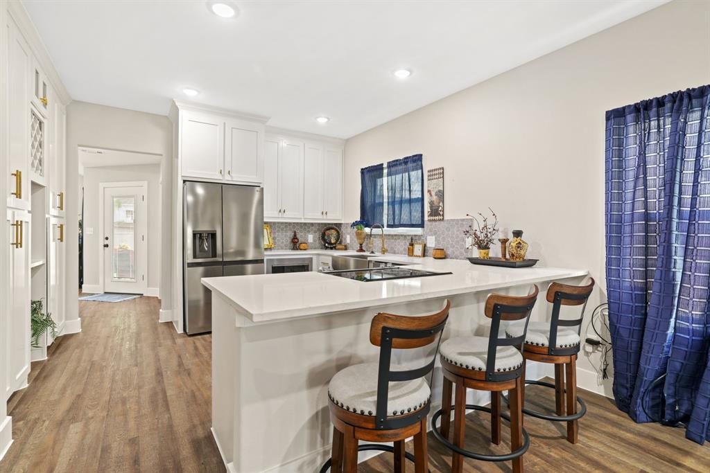 114 West Morton Street Denison, TX 75021 - Photo 7 of 22 a kitchen with refrigerator and chairs