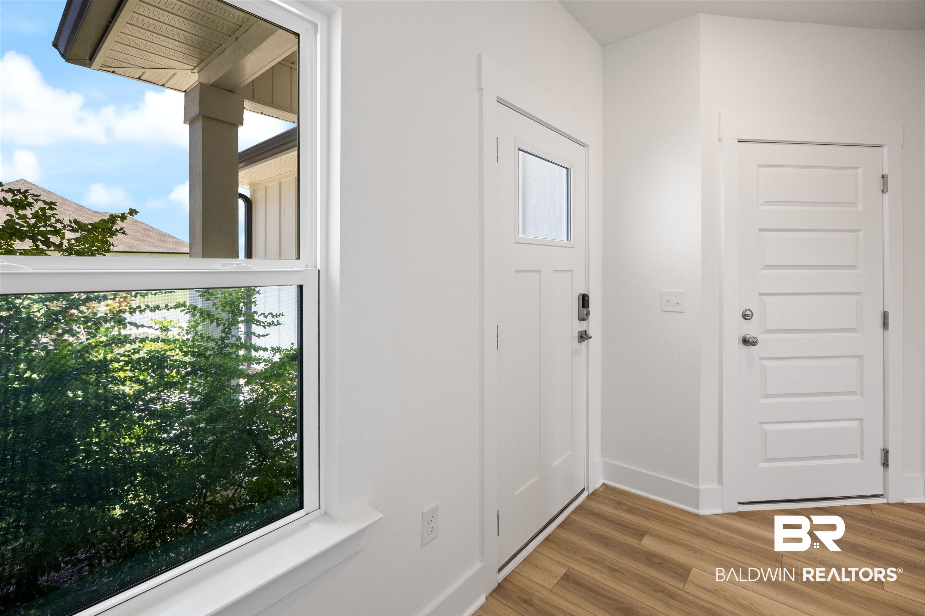 Foyer entrance with baseboards and wood finished floors