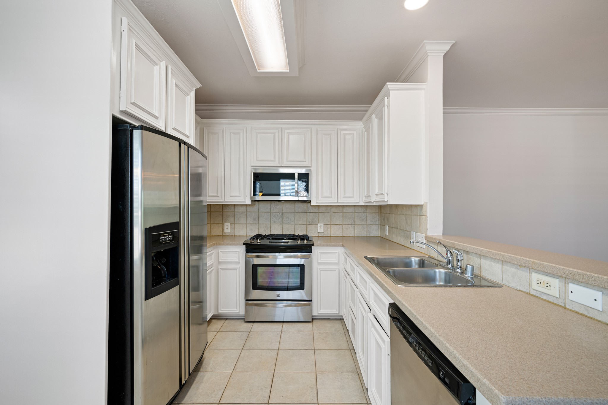 1727 Hadley Street Houston, TX 77003 - Photo 12 of 38 Kitchen features stainless appliances, corian counters and breakfast bar.