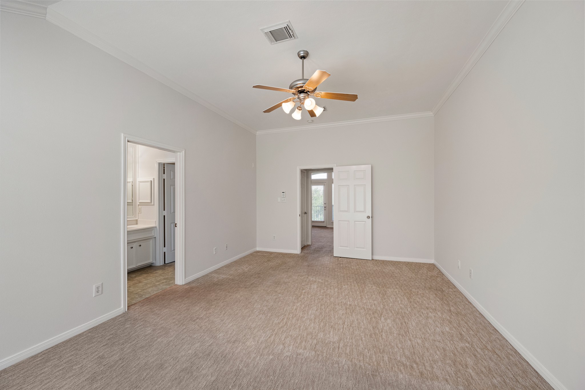 1727 Hadley Street Houston, TX 77003 - Photo 23 of 38 Primary suite offers ceiling fan, crown molding and private bath.