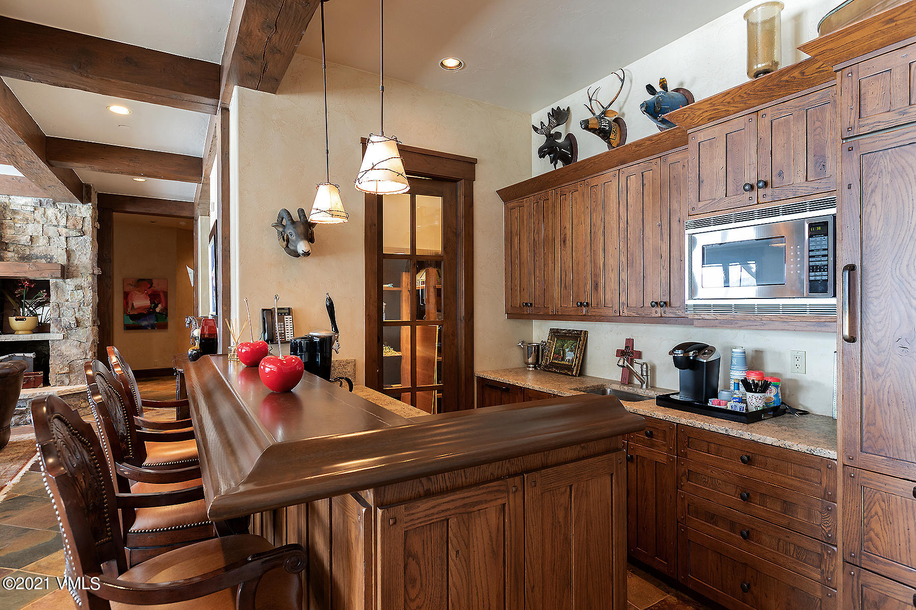 1092 Summit Trail Edwards, CO 81632 - Photo 28 of 48 a kitchen with stainless steel appliances granite countertop a table chairs in it and wooden floors