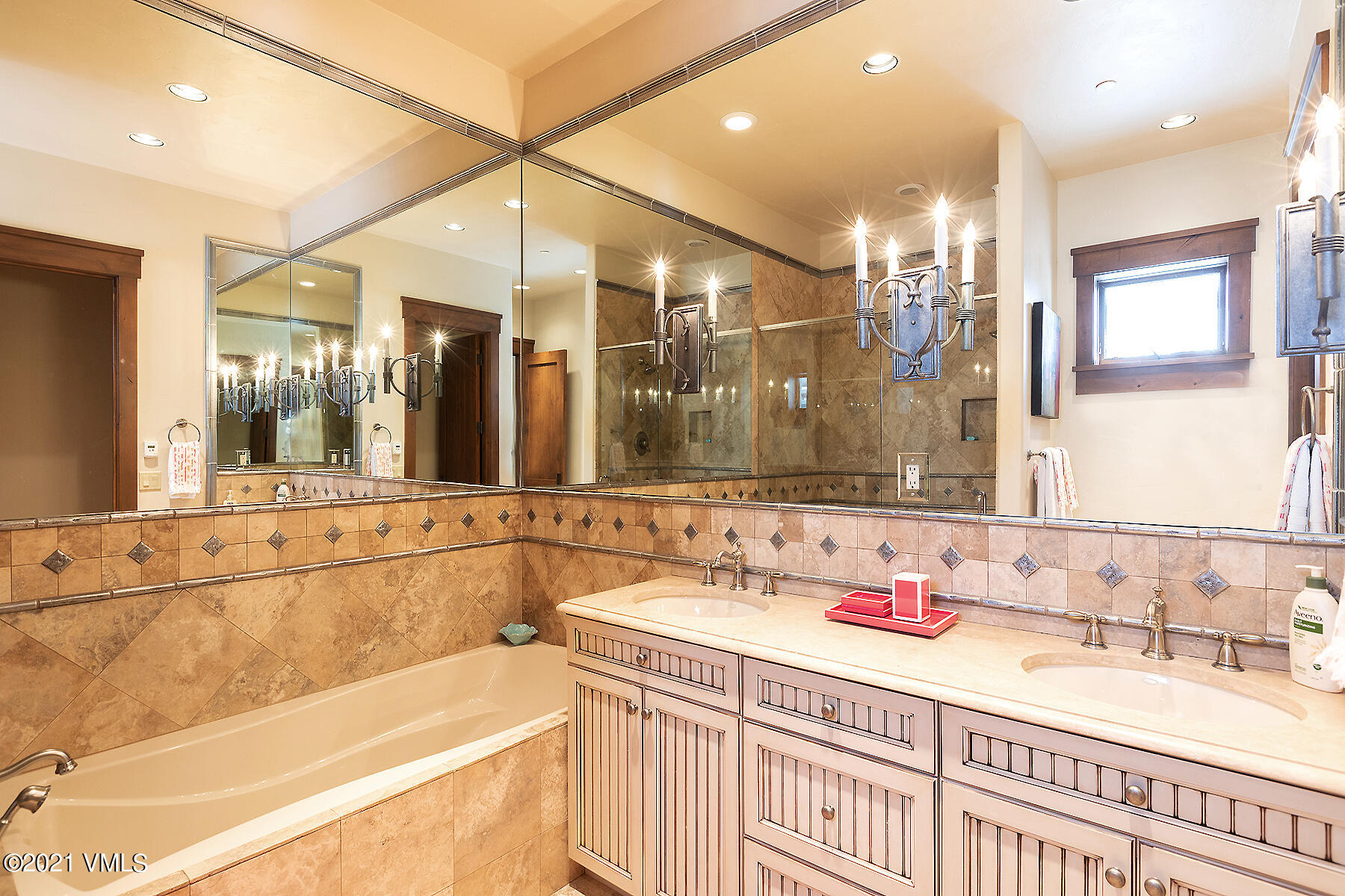 1092 Summit Trail Edwards, CO 81632 - Photo 31 of 48 a bathroom with a bathtub a double vanity sink and a large mirror