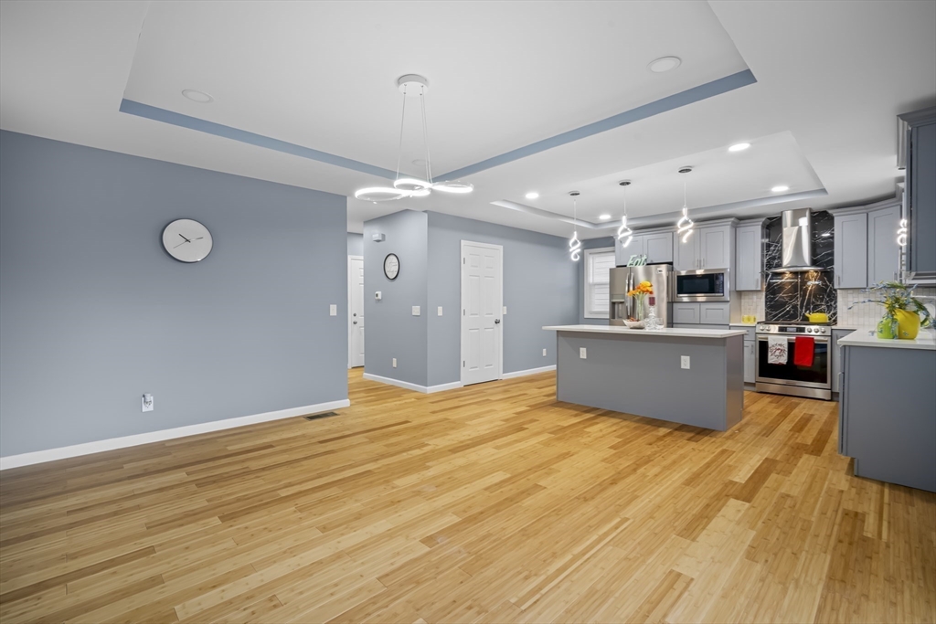9 Quebec Street Springfield, MA 01151 - Photo 6 of 31 a view of kitchen and kitchen with furniture wooden floor and window