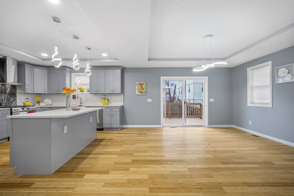 9 Quebec Street Springfield, MA 01151 - Photo 7 of 31 a kitchen with stainless steel appliances granite countertop a refrigerator a sink dishwasher a oven and a dining table with wooden cabinet