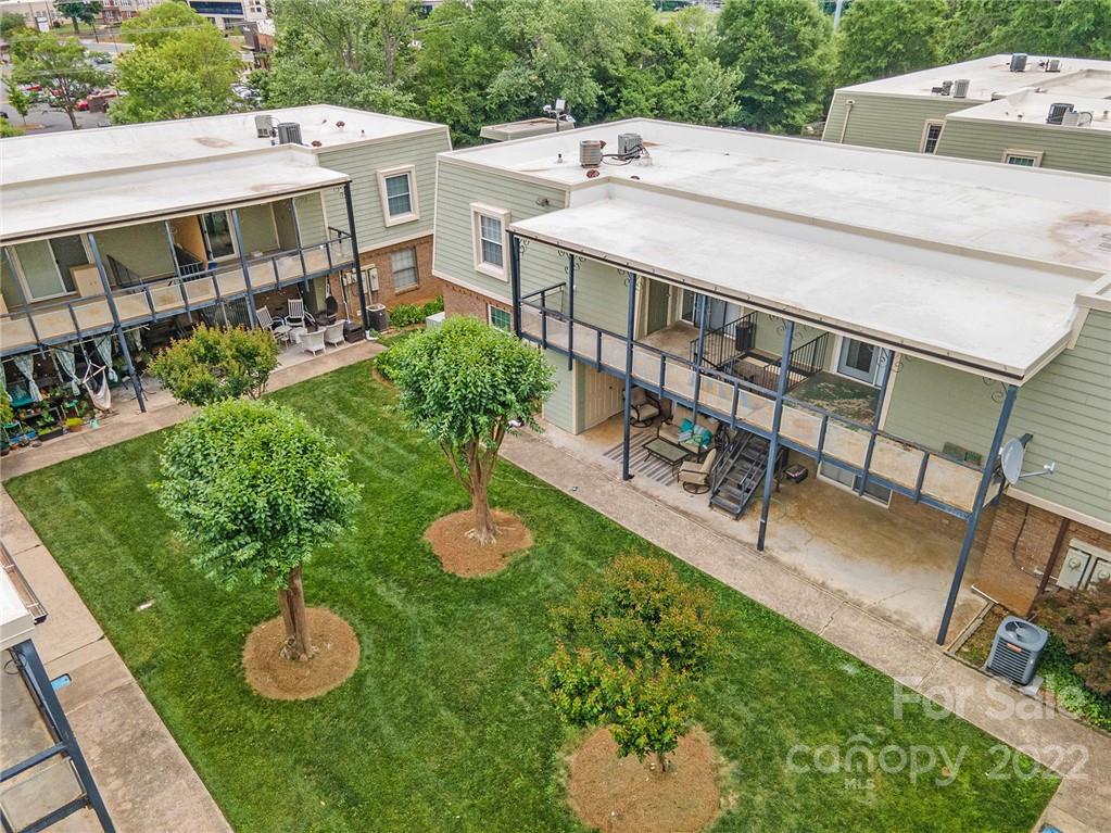 2612 Park Road, Unit D Charlotte, NC 28209 - Photo 19 of 23 a view of a patio with table and chairs potted plants with wooden floor and fence