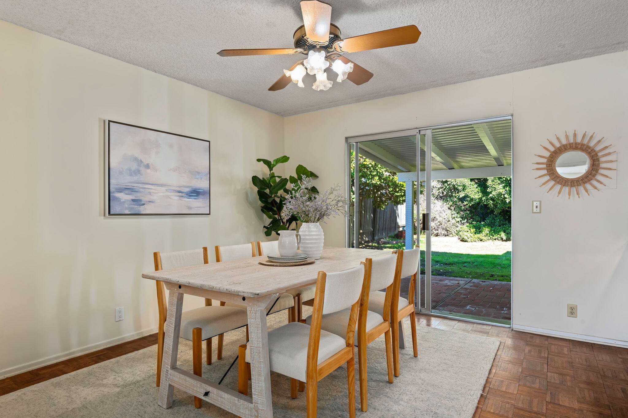 5984 Berkeley Road Goleta, CA 93117 - Photo 7 of 19 a dining room with furniture a large window and a chandelier