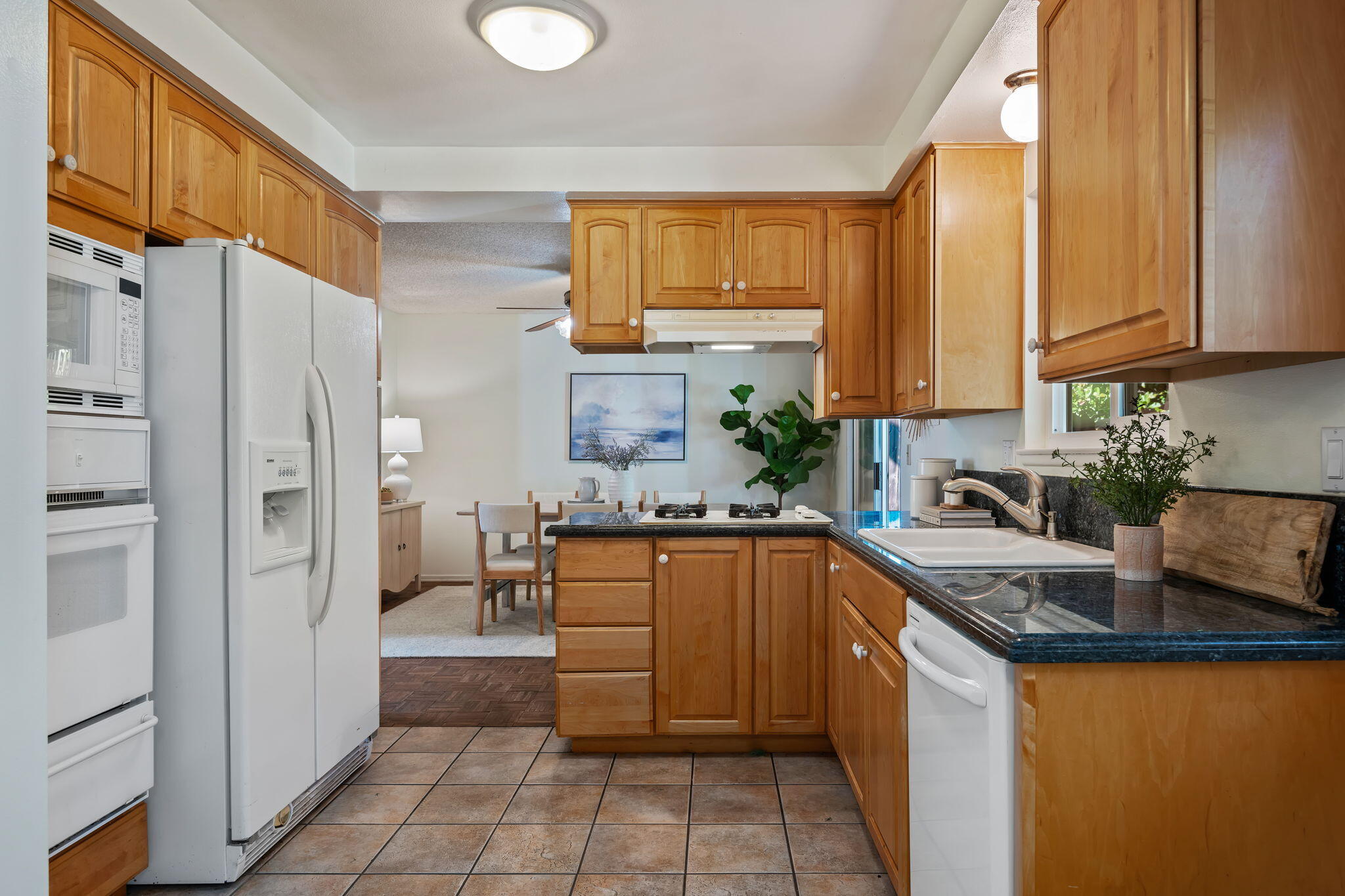 5984 Berkeley Road Goleta, CA 93117 - Photo 9 of 19 a kitchen with stainless steel appliances granite countertop a refrigerator a sink dishwasher a stove with wooden cabinets and a granite counter top