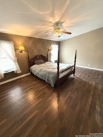 a spacious bedroom with bed and window