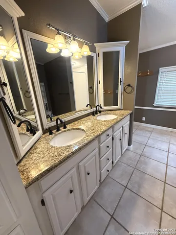 a bathroom with a granite countertop sink and mirror