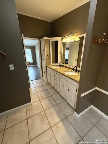 a bathroom with a double vanity sink and mirror