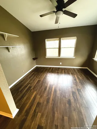 wooden floor in an empty room with a window
