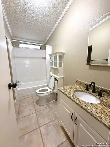 a bathroom with a granite countertop sink a toilet a mirror and shower