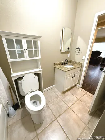 a bathroom with a toilet a sink and a mirror