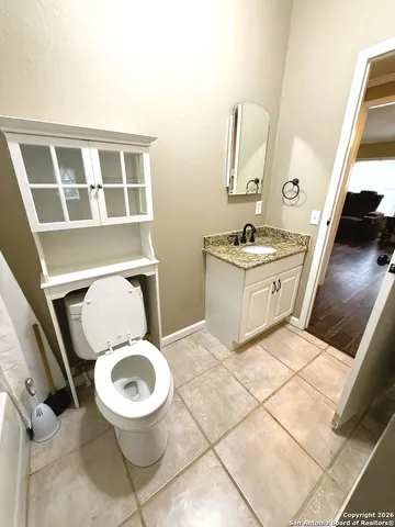 a bathroom with a toilet a sink and a mirror
