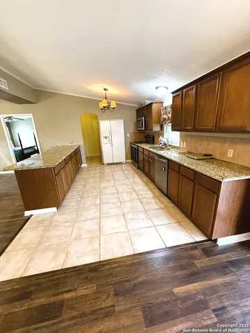 a large kitchen with cabinets and wooden floor