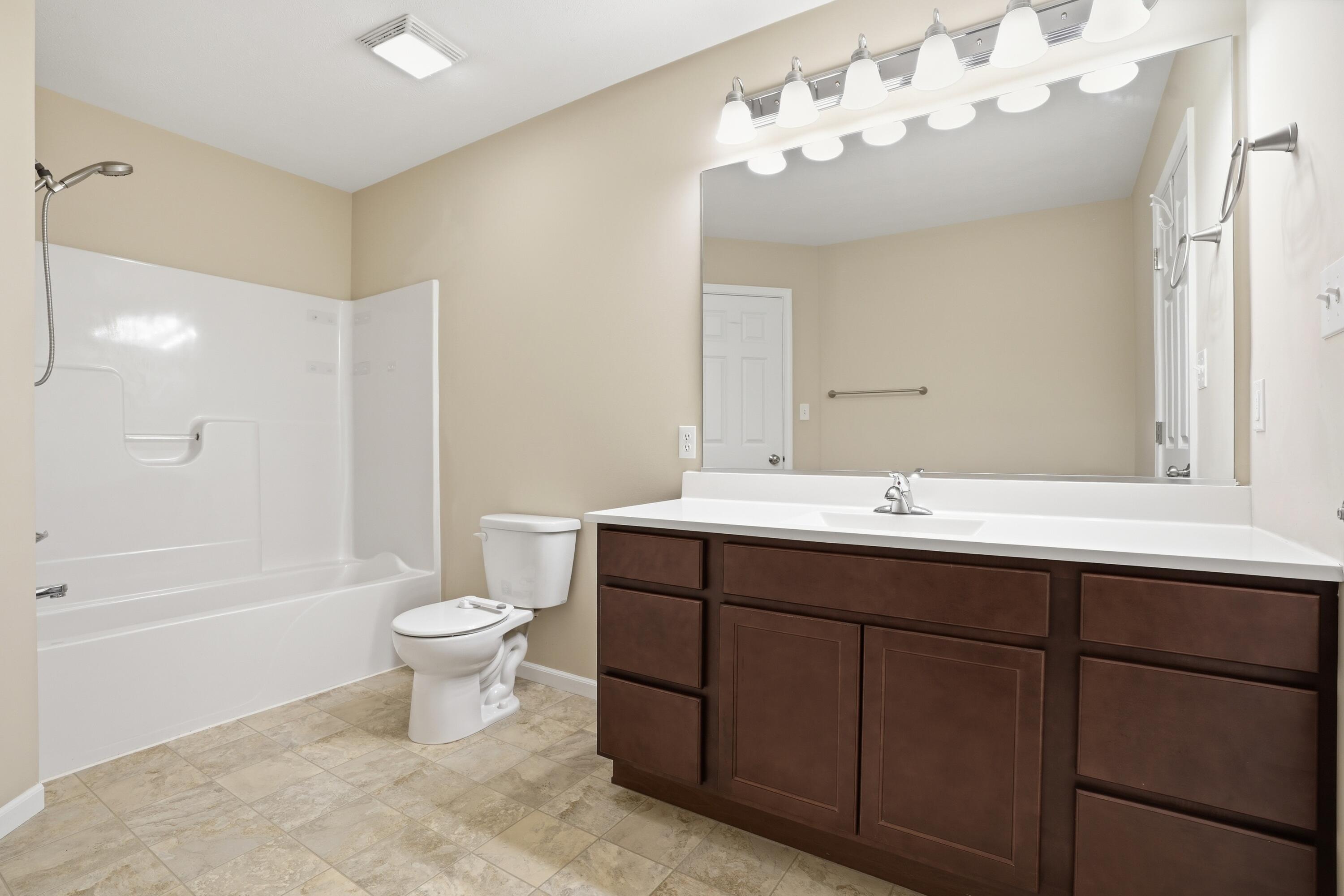 11351 Rhode Island Street Crown Point, IN 46307 - Photo 7 of 18 a bathroom with a double vanity sink mirror toilet and bathtub