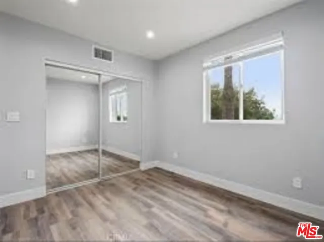 an empty room with a empty space and windows