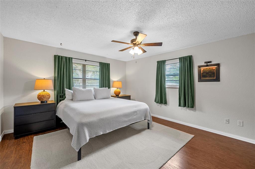 3000 North 15th A Street Waco, TX 76708 - Photo 13 of 24 a bedroom with a large bed and a chandelier