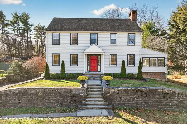 a front view of a house with swimming pool and porch