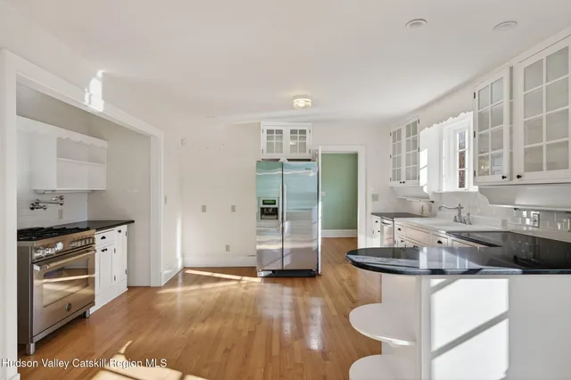 a kitchen with granite countertop a refrigerator and a sink
