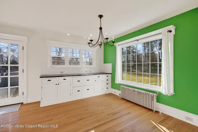 an entryway with wooden floor and windows