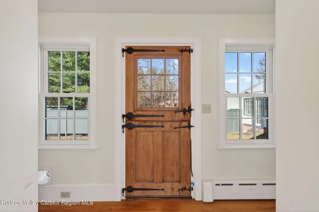 a view of empty room with a fireplace and wooden floor