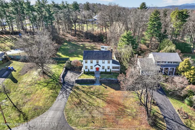 an aerial view of a house with a yard basket ball court and outdoor seating