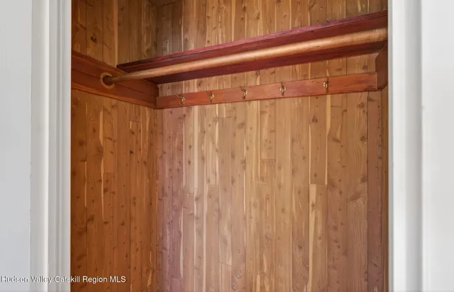 a view of a hallway with wooden floor and windows
