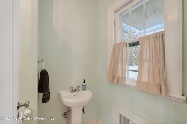 a spacious bathroom with a sink mirror and a bath tub