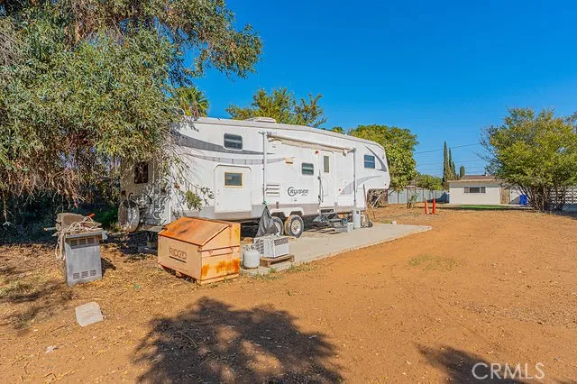 a view of a white house with a large trees