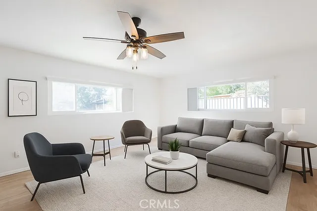 a living room with furniture and a large window