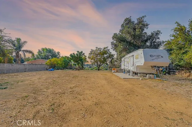 a backyard of a house with lots of green space and trees