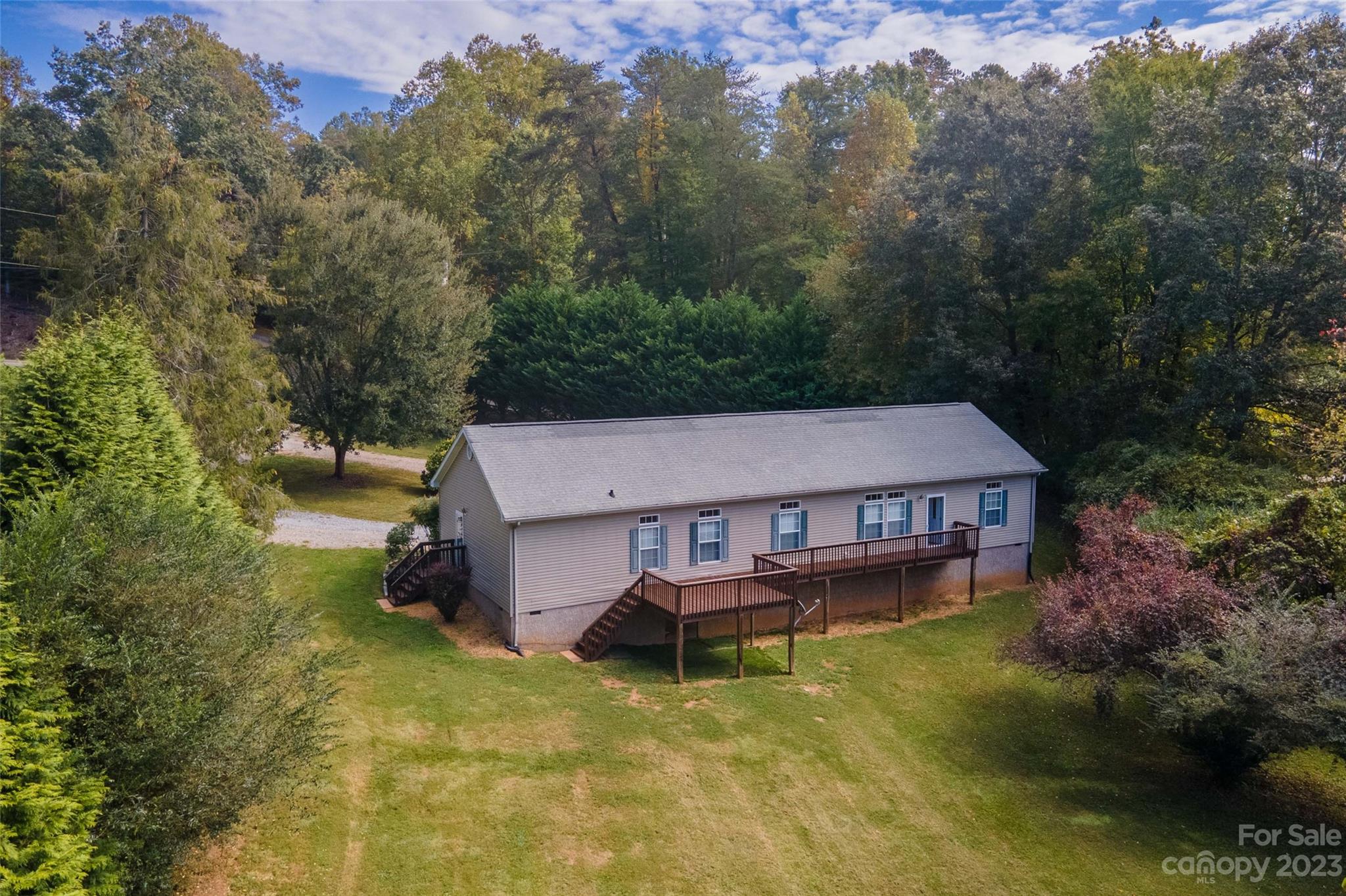 an aerial view of a house with swimming pool and a yard