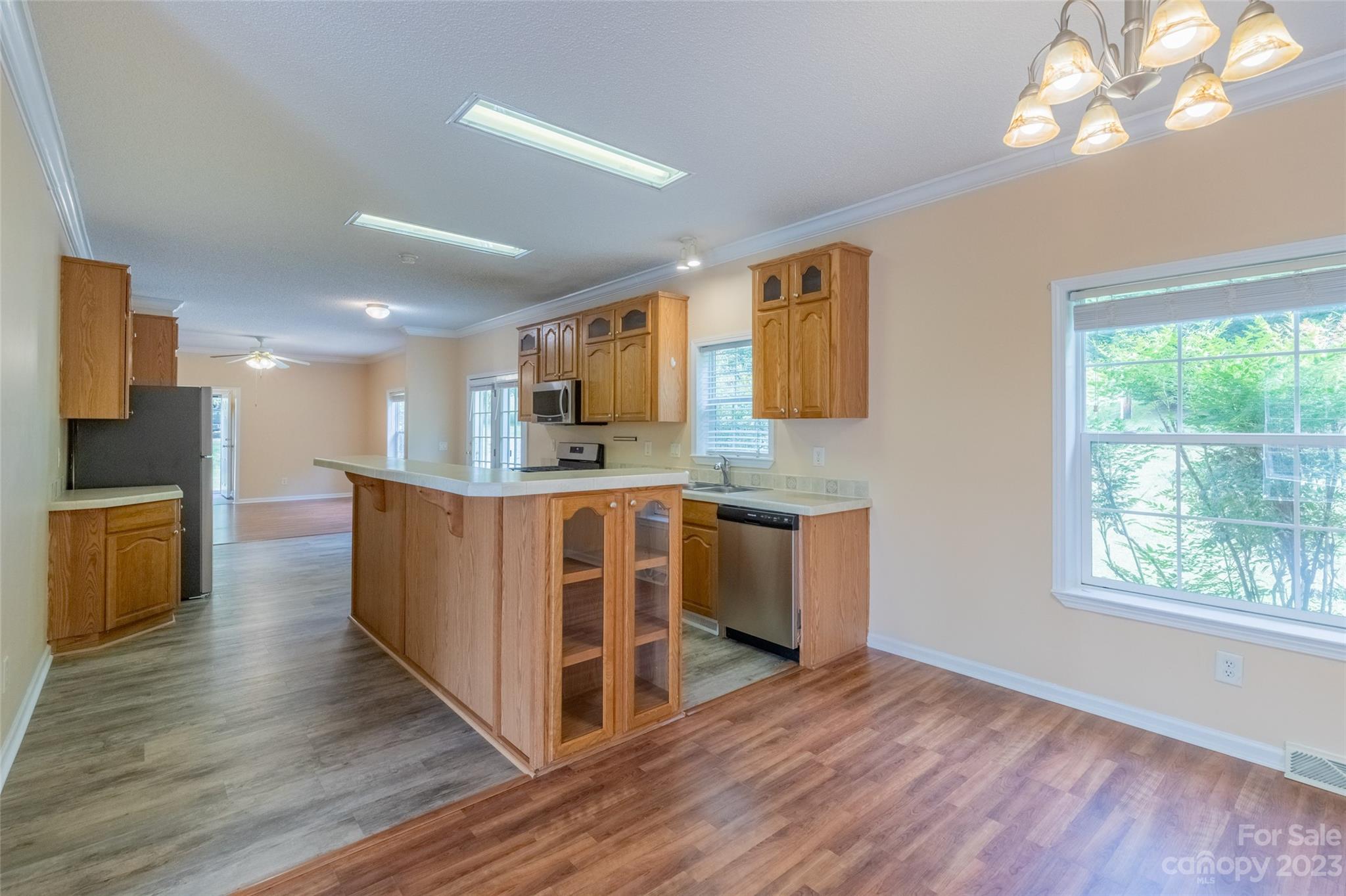 407 Monteith Gap Road Cullowhee, NC 28723 - Photo 11 of 27 a large kitchen with stainless steel appliances granite countertop a large counter top and a wooden floors