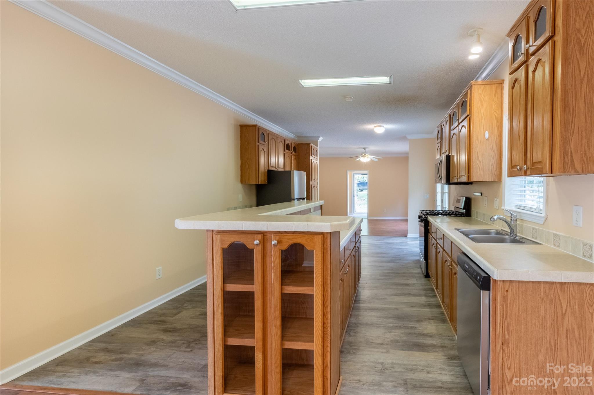 407 Monteith Gap Road Cullowhee, NC 28723 - Photo 12 of 27 a kitchen with wooden cabinets and center island