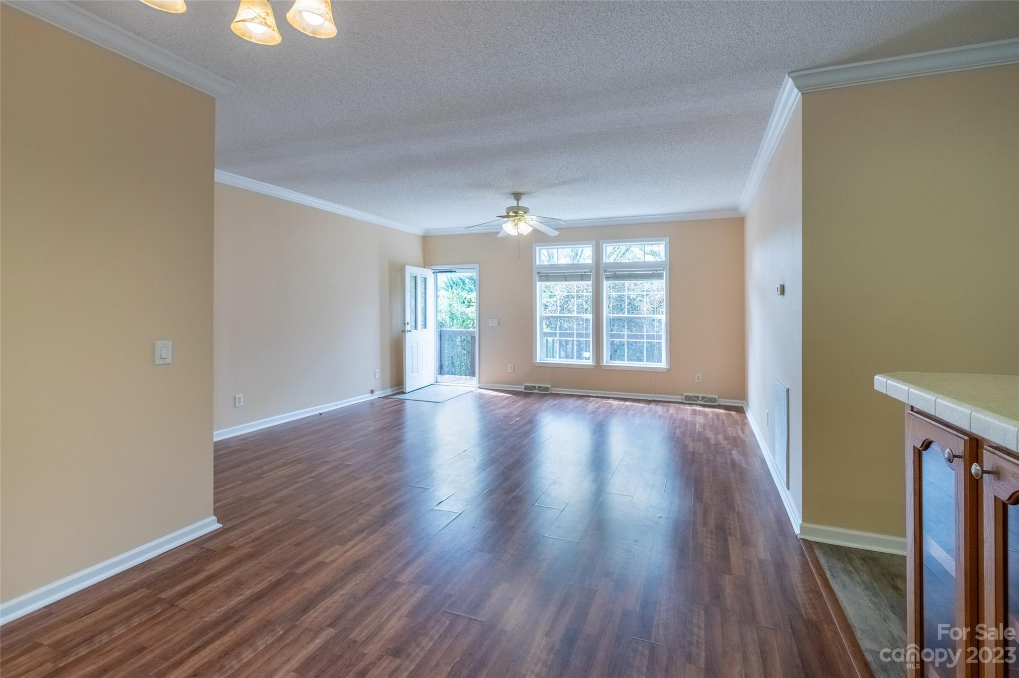 407 Monteith Gap Road Cullowhee, NC 28723 - Photo 13 of 27 an empty room with wooden floor and windows