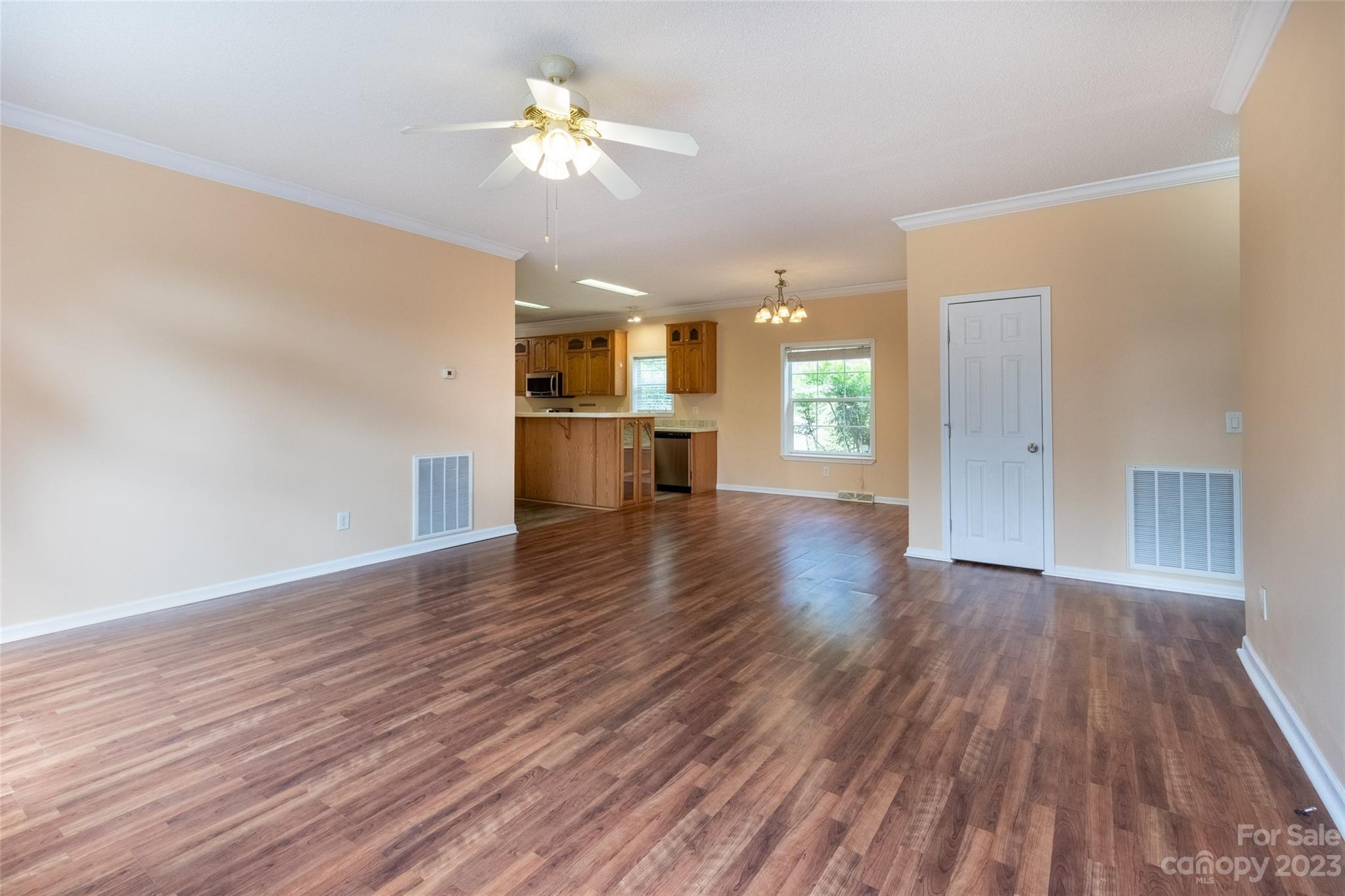 407 Monteith Gap Road Cullowhee, NC 28723 - Photo 14 of 27 a view of a kitchen with wooden floor and a ceiling fan