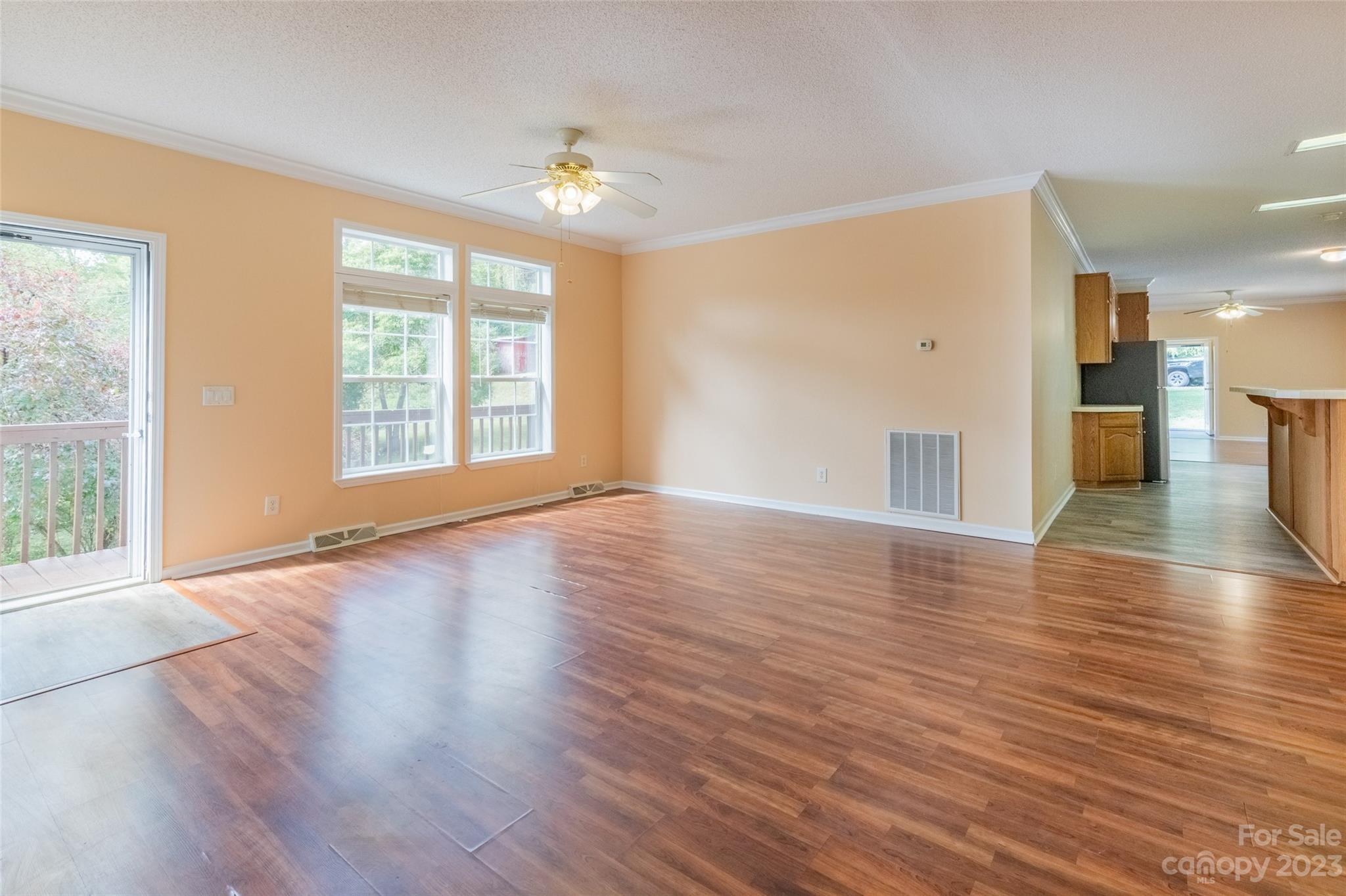 407 Monteith Gap Road Cullowhee, NC 28723 - Photo 15 of 27 a view of an empty room with wooden floor and a window